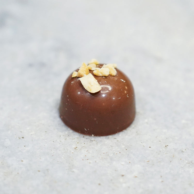Milk chocolate Tempered peanut butter truffle topped with chopped peanuts.